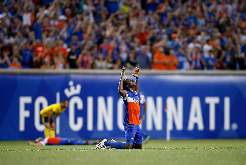 Award of Excellence, Ron Kuntz Sports Photographer of the Year - Sam Greene / The Cincinnati EnquirerFC Cincinnati forward Djiby Fall (9) drops to his knees in celebration as time expires in the second half of the US Open Cup soccer match between FC Cincinnati and Columbus Crew at Nippert Stadium in Cincinnati on Wednesday, June 14, 2017. FC Cincinnati defeated its MLS opponent, 1-0, in front of a record crowd of more than 30,000 fans, advancing to the next round of the US Open Cup. 