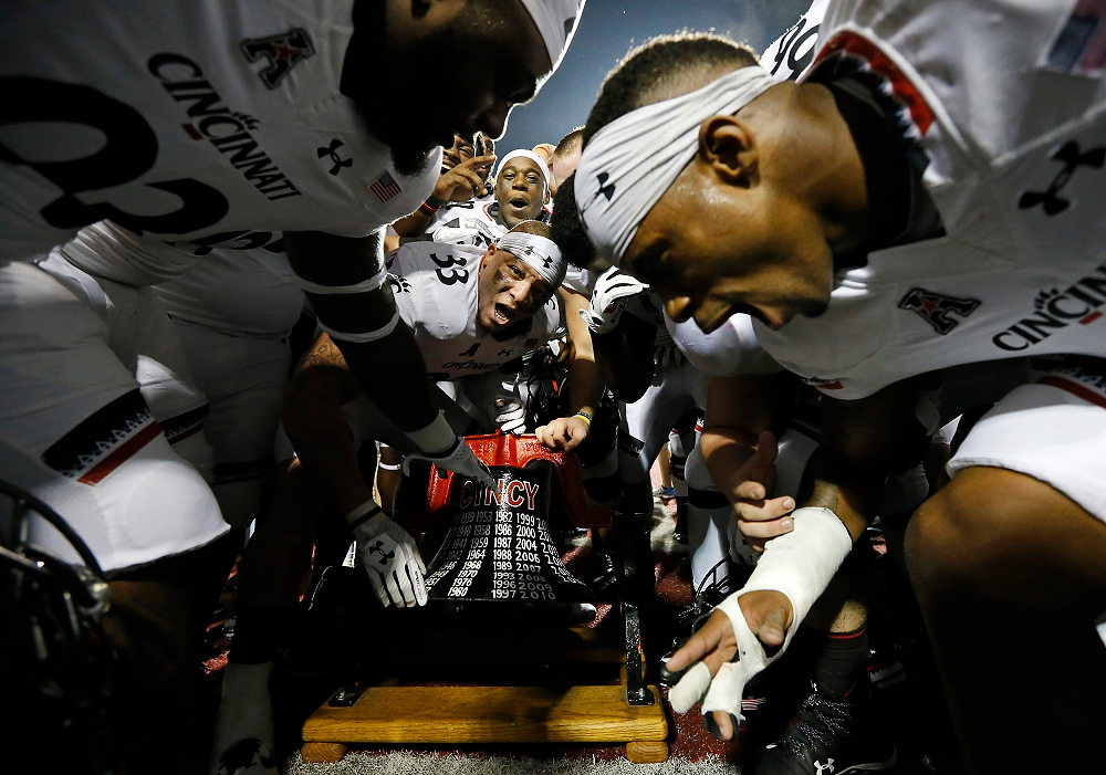 Award of Excellence, Ron Kuntz Sports Photographer of the Year - Sam Greene / The Cincinnati EnquirerThe Cincinnati Bearcats celebrate with the Victory Bell after the fourth quarter of the NCAA college football game between the Miami Redhawks and the Cincinnati Bearcats at Yager Stadium in Oxford, Ohio, on Saturday, Sept. 16, 2017. The Bearcats won 21-17 after an intercepted RedHawks pass was returned for a touchdown with just over one minute remaining in the game. UC retains the Victory Bell for the 12th-straight year.