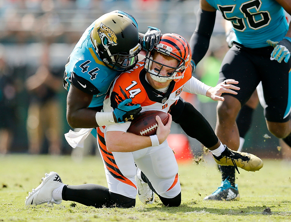 Award of Excellence, Ron Kuntz Sports Photographer of the Year - Sam Greene / The Cincinnati EnquirerCincinnati Bengals quarterback Andy Dalton (14) is brought down by Jacksonville Jaguars outside linebacker Myles Jack (44) with no flag thrown in the first quarter of the NFL Week 9 game between the Jacksonville Jaguars and the Cincinnati Bengals at EverBank Field in Jacksonville, Fla., on Sunday, Nov. 5, 2017. 