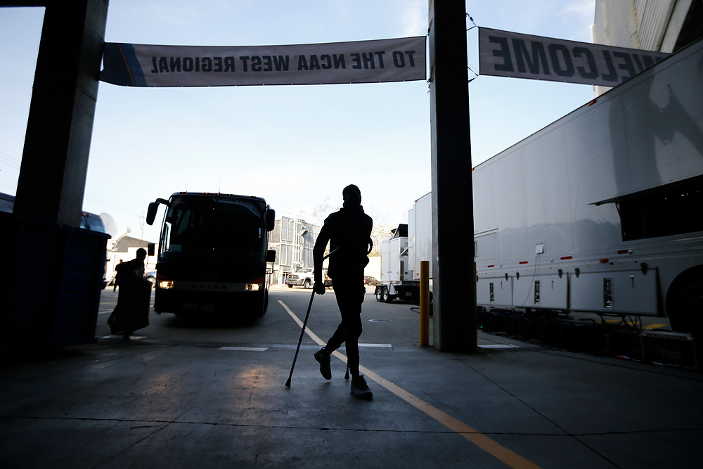 Award of Excellence, Ron Kuntz Sports Photographer of the Year - Sam Greene / The Cincinnati EnquirerInjured star guard Edmond Sumner walks off the bus on crutches arrives at the arena ahead of the Sweet 16 matchup between the Xavier Musketeers and the Arizona Wildcats at the SAP Center in San Jose, Calif., on Thursday, March 23, 2017. Sumner would declare for the draft shortly after the season finale.