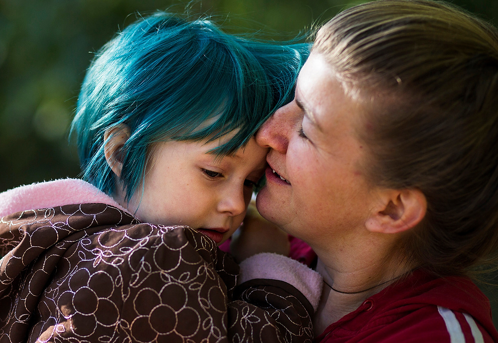 First Place, Chuck Scott Student Photographer of the Year - Erin Clark / Ohio UniversityClaire kisses her daughter, four-year-old Grace, at Twin Oaks Community. Grace recently dyed her hair blue after her friend Franky, also four, dyed her hair earlier in the week.