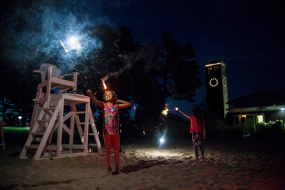 First Place, Chuck Scott Student Photographer of the Year - Erin Clark / Ohio UniversityiNova Holland, left, and her sister Hana of Los Angeles, CA celebrate the fourth of July on Children’s Beach in Chautauqua, New York, 