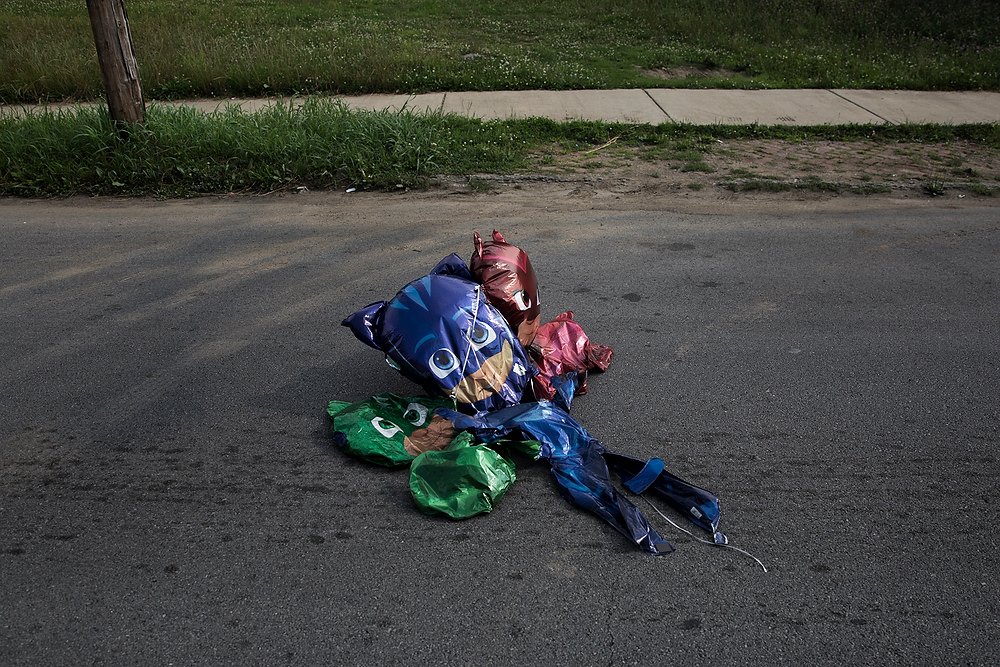 Second Place, Chuck Scott Student Photographer of the Year - Liz Moughon / Ohio UniversityOver a month after Dequante's funeral, deflated Paw Patrol balloons blow into the street after barely holding onto his front porch rail. These were his favorite cartoon characters.
