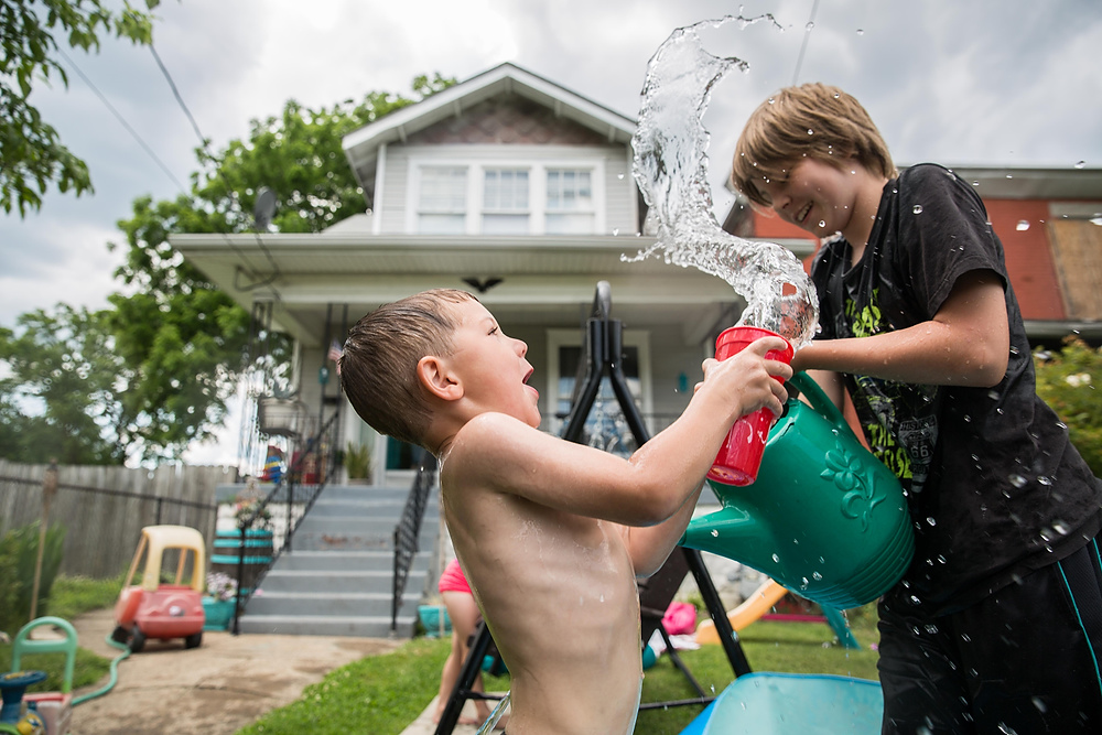 Second Place, Chuck Scott Student Photographer of the Year - Liz Moughon / Ohio UniversityCousins Logan McWhorter, left, and Ethen Holliger, right, battle it out by dumping cold water on each other to cool off on a summer afternoon at their grandparents' house in Louisville, KY.
