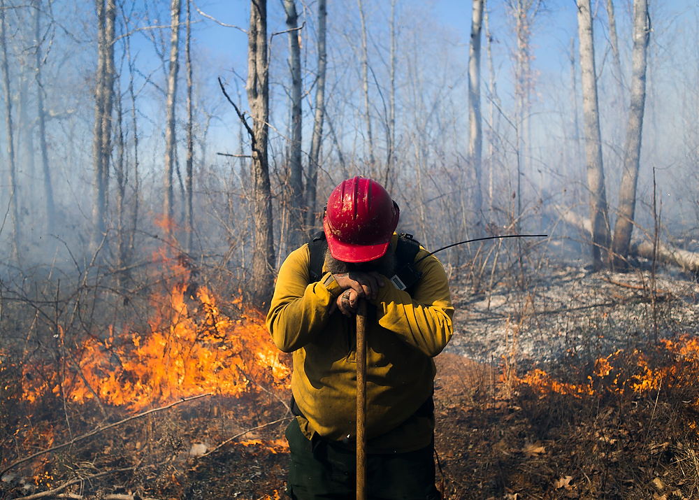 Third Place, Chuck Scott Student Photographer of the Year - Emma Howells / Ohio UniversityFirefighter Jason Bew takes a quiet moment during a prescribed burn in the Wayne National Forest. Bew is the "Burn Boss," on the fire, meaning that it is his responsibility to plan, direct and oversee every aspect of the fire.