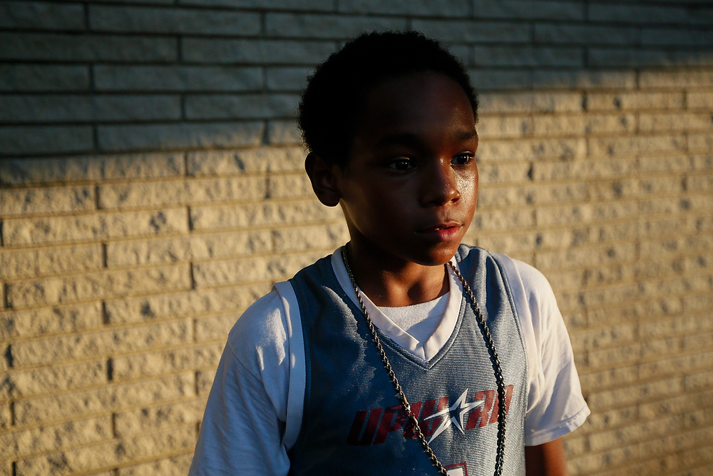 Third Place, Chuck Scott Student Photographer of the Year - EMMA HOWELLS / Ohio UniversityJulius Preston poses for a portrait while waiting for his ride after the first Tulsa Midnight Basketball event at the Spirit Life Church in Tulsa, OK on Friday, June 16, 2017.
