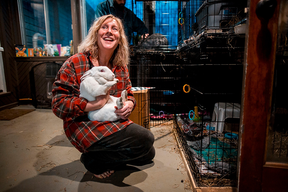 First Place, Chuck Scott Student Photographer of the Year - Erin Clark / Ohio UniversitySuzanne Grief, owner of River Road Rabbit Rescue, cleans rabbit cages in her home in Athens, Ohio. 