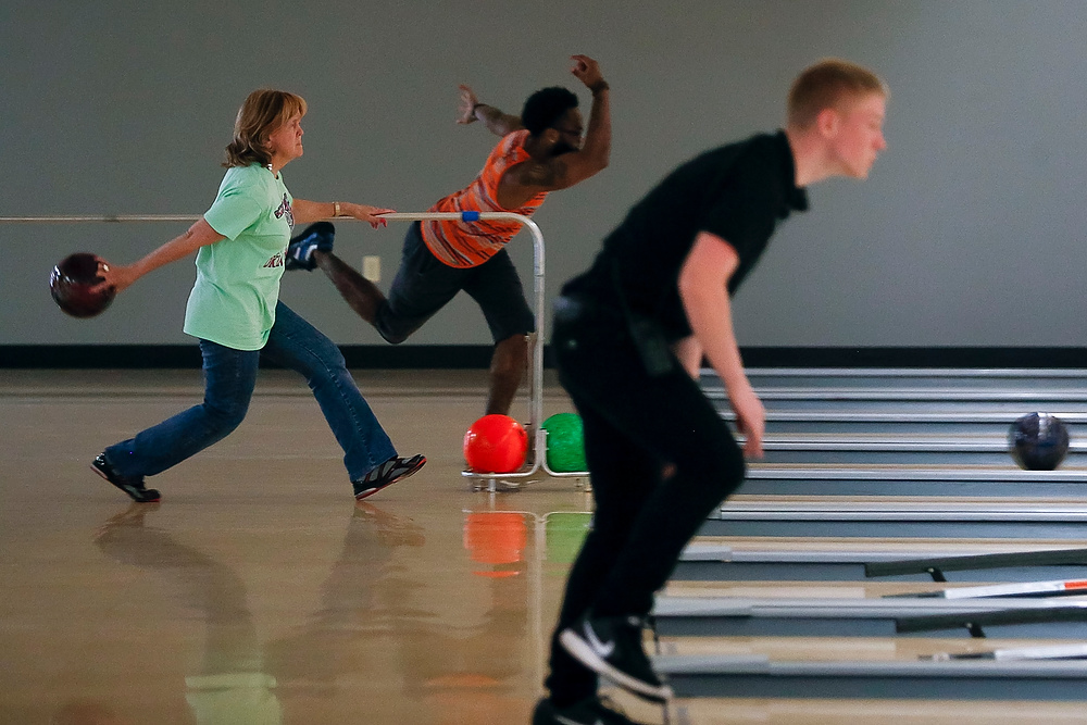Third Place, Chuck Scott Student Photographer of the Year - Emma Howells / Ohio UniversityJeri throws a bowling ball alongside other bowlers at Andy B's lanes in Tulsa, Oklahoma. She founded a bowling league for blind bowlers. The rail assists her in keeping a straight path to the lane.