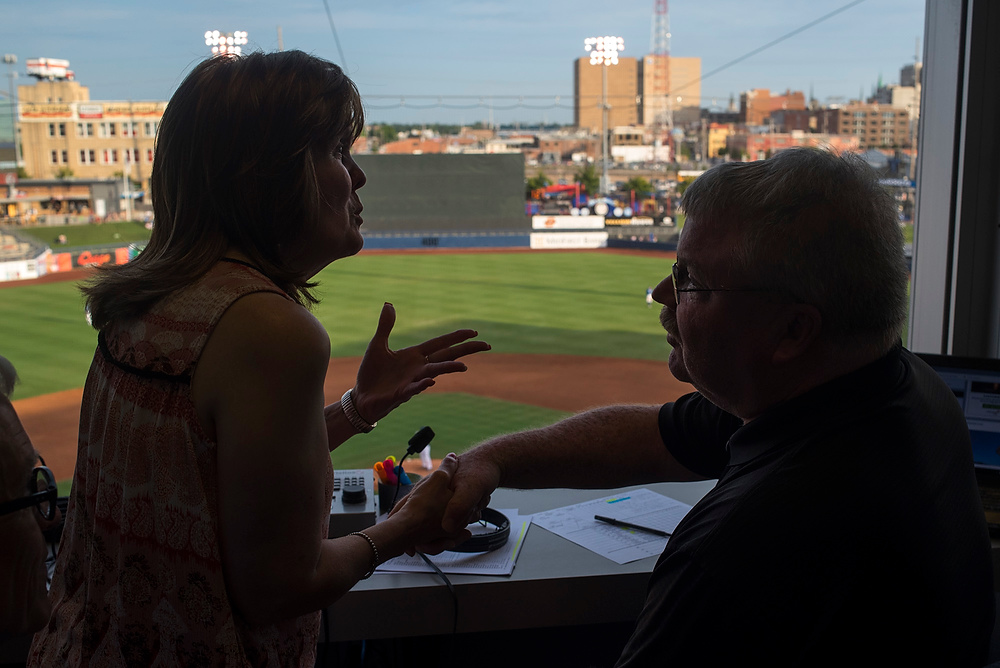 Third Place, Chuck Scott Student Photographer of the Year - Emma Howells / Ohio UniversityJeri signs, "Thank you," to Tulsa Drillers' announcer Dennis Higgins after he invited her to sit in on his live broadcast of the game. Jeri listens to Drillers' games on the radio and wanted to how communicate the importance of radio announcers' importance to the blind community.