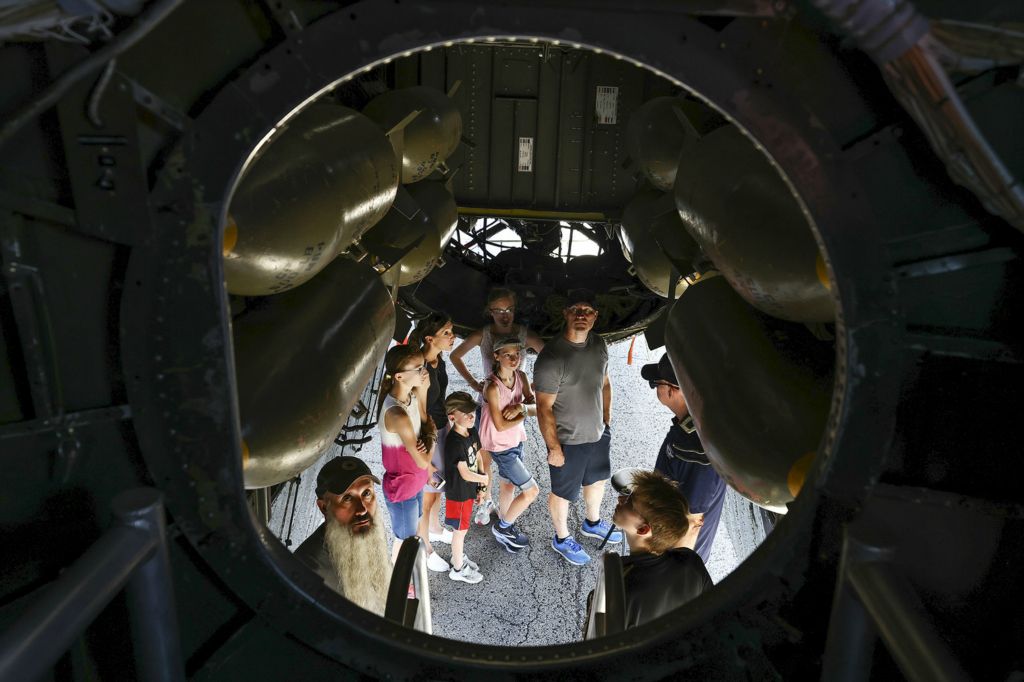 August - Story - 3rd place - Bill Czinski, bottom left, of Tecumseh, Mich., looks inside of a Boeing B-29 Superfortess during the Commemorative Air Force AirPower History Tour Friday, August 19, 2022, at Eugene F. Kranz Toledo Express Airport in Swanton. (Jeremy Wadsworth / The Blade)