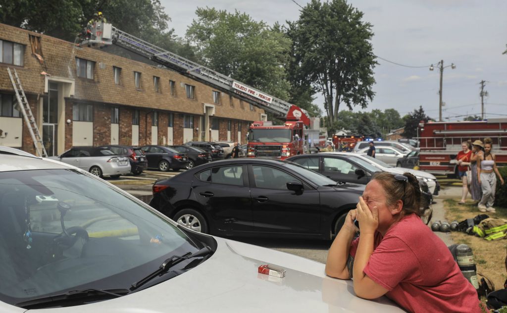 July -  Spot News - 1st place - Stephanie Hehl reacts as her apartment at Hunt Club Apartments burns down in Sylvania. Hehl said “My whole life is crumbling apart.”  (Jeremy Wadsworth / The Blade) 