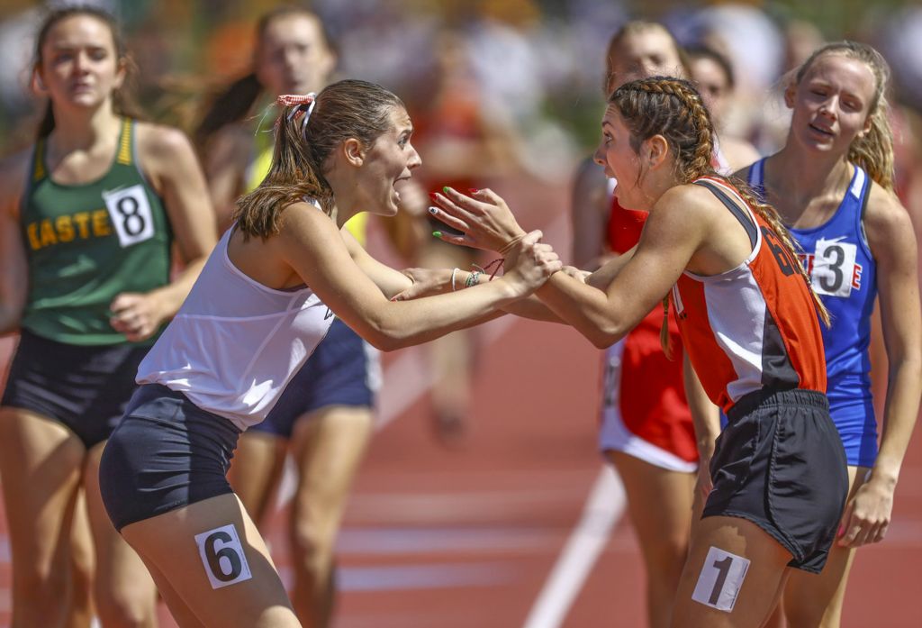 June - Sports Feature - 1st place - Haley Alig (left) of Coldwater congratulates Taylor Roth of Minster on winning the Division III 800 meter run during the OHSAA State Track Meet at Jessie Owens Memorial Stadium in Columbus. (Jeremy Wadsworth / The Blade)