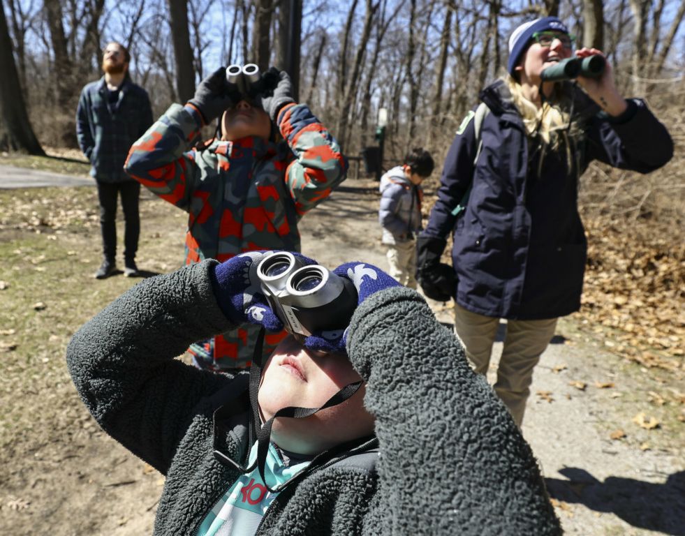 March - Feature - 1st place - Lukas Grothaus, 6, looks for birds while on a nature walk during a Spring Sprouts Mini-Camp at Wildwood Metropark in Toledo. (Jeremy Wadsworth / The Blade)