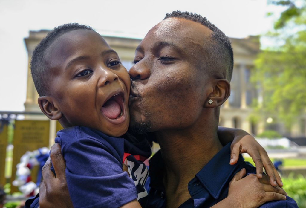 May - General News - 2nd place - Olatunji Muyideen Yusuff, originally from Nigeria, kisses his son Wareez, 4, after becoming a US citizen during a Naturalization Ceremony Thursday, May 19, 2022, at the Civic Center Mall in Toledo.  (Jeremy Wadsworth - The Blade)  