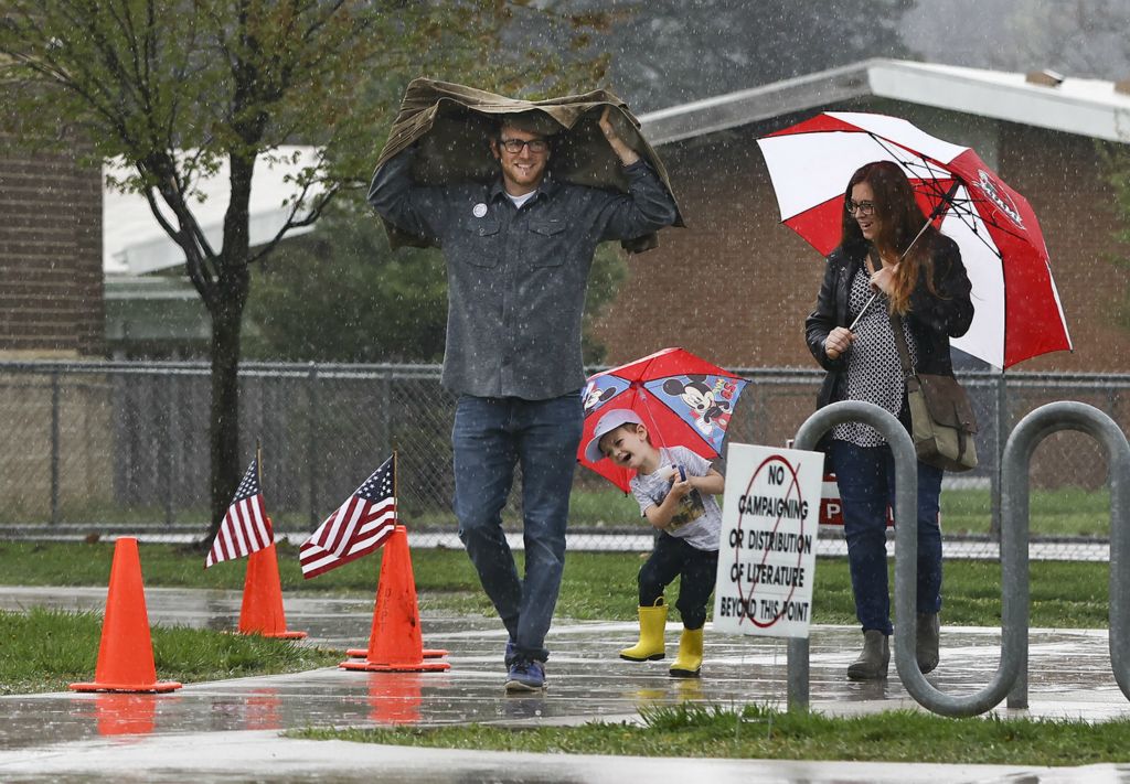 May - General News - 3rd place - Mitch Kaiser along with wife Cambra Kaiser and son Eijah, 4, head to their car in the pouring rain after voting Tuesday, May 3, 2022, at Old Orchard Elementary School in Toledo.  (Jeremy Wadsworth - The Blade)  