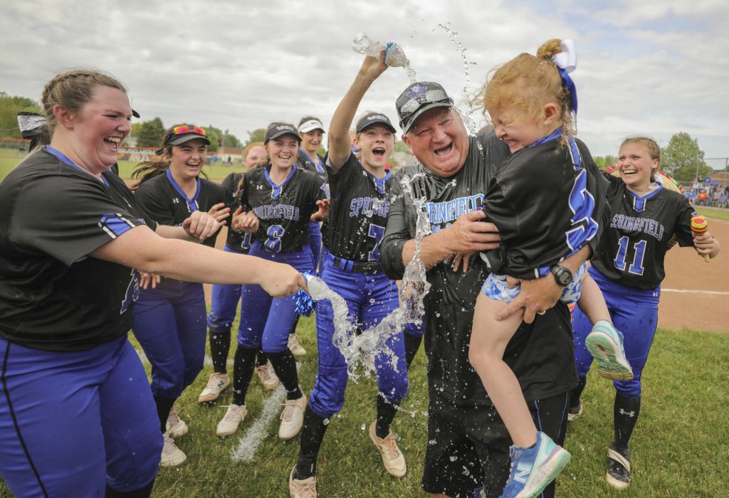May - Sports Feature - 1st place - Springfield head coach Rob Gwozdz and his granddaughter Hallee Hall, 4, are doused with water after the Blue Devils defeated  Anthony Wayne, 5-4, during an OHSAA Division I regional semifinal softball game at Gibsonburg High School in Gibsonburg.   (Jeremy Wadsworth - The Blade)  