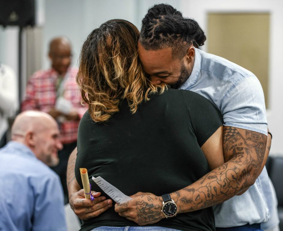 November - Story - 1st place - Inmate Daquan Brown hugs a family member after being awarded aa Business Operations Certificate during an Education Recognition Ceremony at Toledo Correctional Institution. The ceremony is for incarcerated adults that have successfully completed programs.  (Jeremy Wadsworth / The Blade)