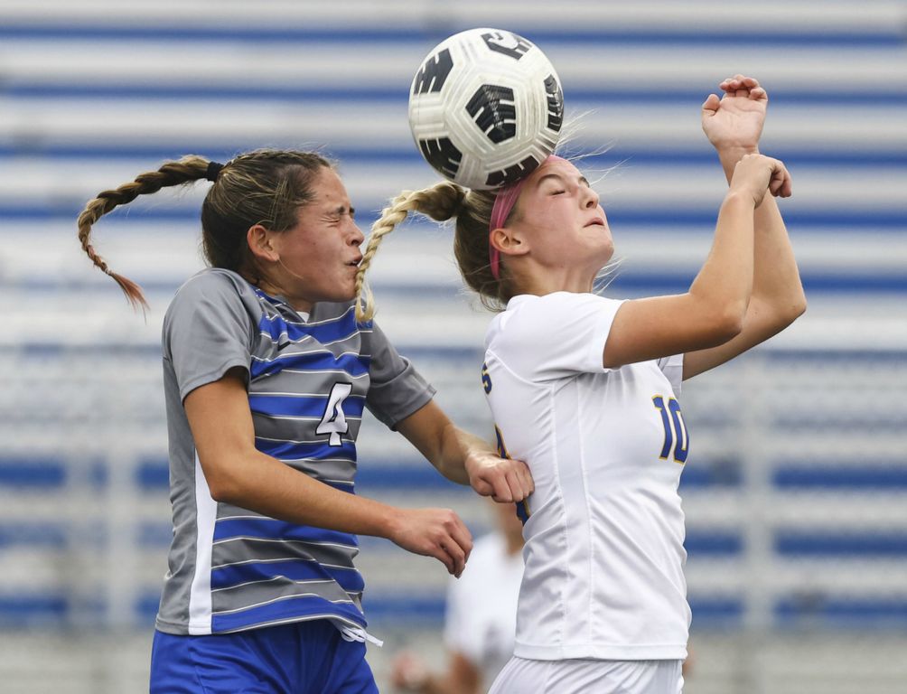 October - Sports - 3rd place - Anthony Wayne’s Kiana Harsh (left) battles  St. Ursula’s Emma Helminski for the ball during a Division I district semifinal game at Springfield High School in Holland.  (Jeremy Wadsworth / The Blade)