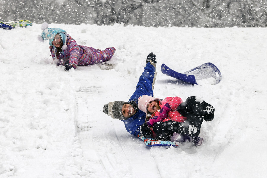 January - Feature - 1st place - Richard Bensman sleds with his daughters, Paige, 5, and Cora, 10, (top left) at Ottawa Park in Toledo.   (Jeremy Wadsworth / The Blade)