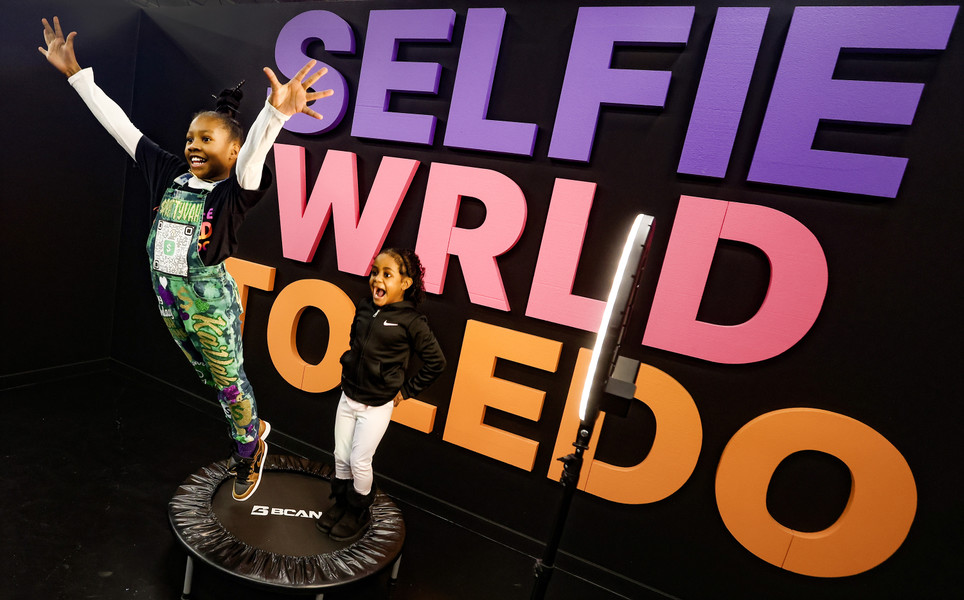 January - Feature - HM - Ká Vah Rose, 9, and Rhyleigh Woodward, 9, jump on a trampoline at Selfie WRLD in Toledo.  (Jeremy Wadsworth / The Blade)