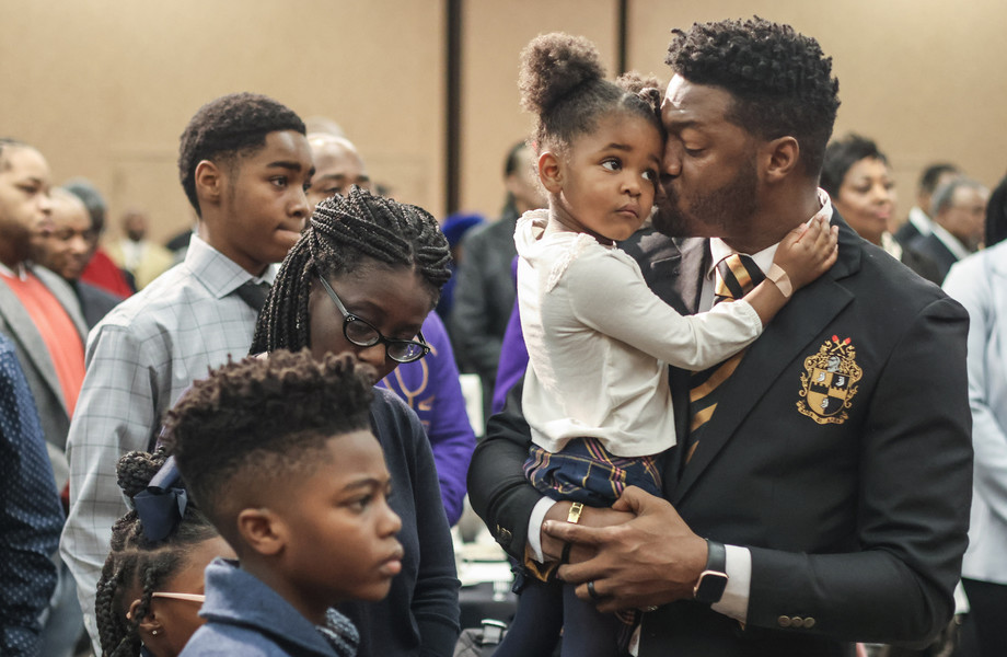 January - General News - 2nd place - Corey Parker of Toledo kisses his daughter Ashlynn, 3, as “Lift Every Voice and Sing” is played by Mike Willams during the 31st annual Dr. Martin Luther King, Jr. Scholarship Breakfast at The Pinnacle in Maumee.  (Jeremy Wadsworth / The Blade)