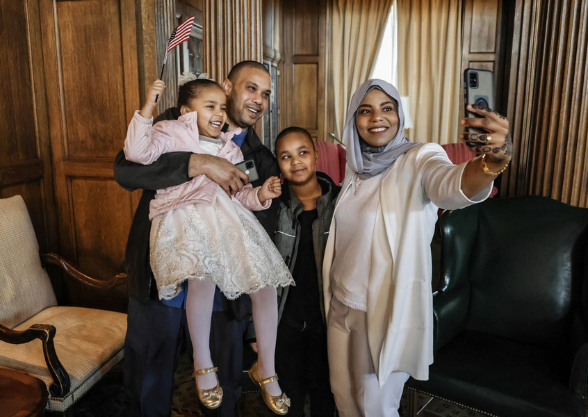 January - Story - 3rd place - Mohamed Hashim, originally from Sudan, celebrates becoming a U.S. Citizen by taking a selfie with his wife Ihsan, daughter Jenan, 4, and son Ayman, 8, after a Naturalization Ceremony at the Toledo Club in Toledo.   (Jeremy Wadsworth / The Blade)
