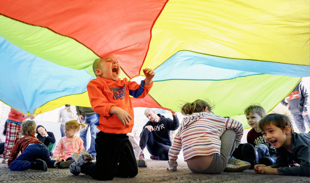 February - Feature - 1st place - Koda Himes, 2, of Sylvania plays under a parachute during a dance party for kids ages 2-5 at the King Road Library in Sylvania.   (Jeremy Wadsworth / The Blade)