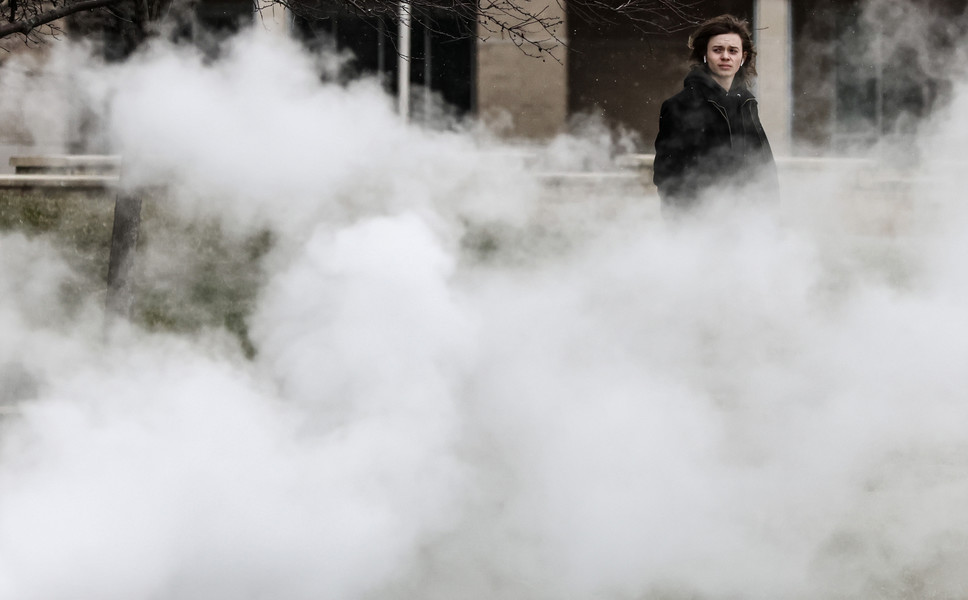 February - Feature - 2nd place - Aaron Hoegner, University of Toledo freshman, walks through steam and 24 degree weather past the Ottawa House West residence hall at the University of Toledo. (Jeremy Wadsworth / The Blade)