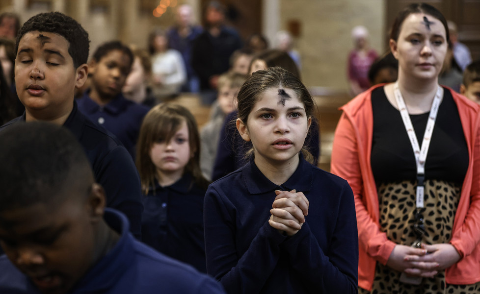 February - General News - 3rd place - Violet Marks, 10, prays during an Ash Wednesday service at Blessed Sacrament in Toledo.   (Jeremy Wadsworth / The Blade)
