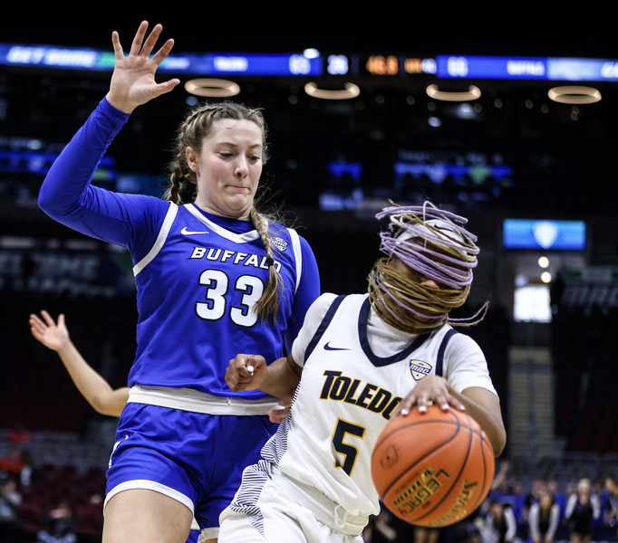 March - Sports - 1st place - University of Toledo guard Quinesha Lockett drives past Buffalo’s Hattie Ogden during the quarterfinals of the MAC bsketball tournament at the Rocket Mortgage FieldHouse in Cleveland. UT defeated Buffalo, 75-74, in overtime. (Jeremy Wadsworth / The Blade)