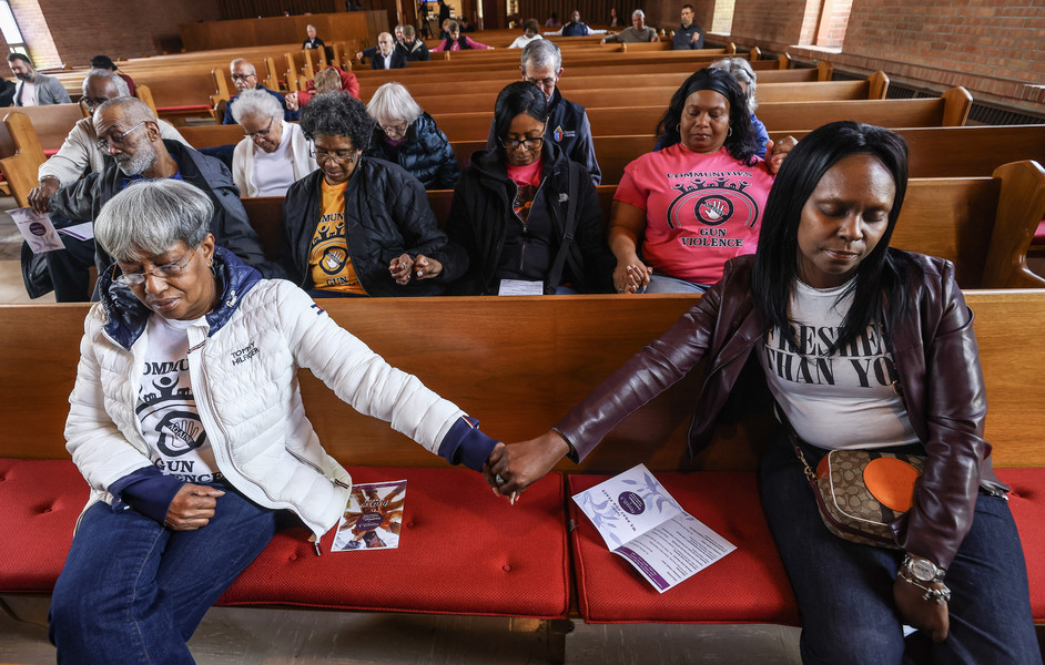 April - General News - 3rd place -  Arlene Agnes (left) holds hands with Tiffany McMorris during a prayer service for victims of gun violence at Epworth United Methodist Church in Toledo. The two are praying for their relative Christoper Kinnebrew who was fatally shot.   (Jeremy Wadsworth / The Blade)