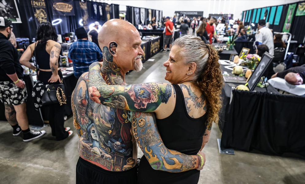 April - Portrait - 2nd place - Chris McCrea and his wife Michelle McCrea of Adrian, Michigan, explore the Toledo Tattoo Festival at the Glass City Convention Center in Toledo.  (Jeremy Wadsworth / The Blade)