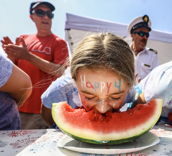 Juy - General News - 1st place - Clara Mayers, 10, of Toledo wishes everyone a happy holiday while competing in the annual watermelon eating contest as part of the Harvard Circle Fourth of July Celebration in Toledo.  (Jeremy Wadsworth / The Blade)