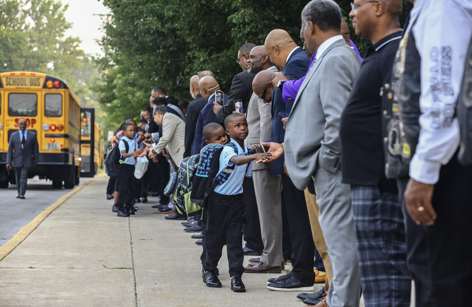 August - Feature - HM - Officials and community members greet students on the first day of school at MLK Jr. Academy for Boys in Toledo. (Jeremy Wadsworth / The Blade)