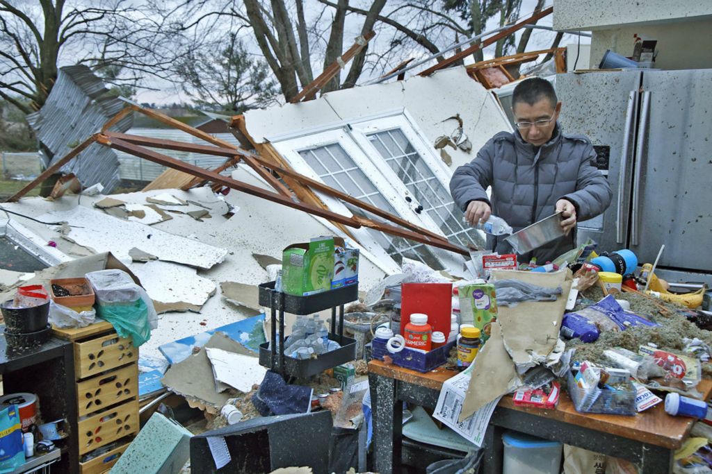  Spot News - 1st place - Shoji Uota pours his dog some fresh water after finding the dog's bowl in the remains of his kitchen. Uota's house was destroyed a few hours earlier in an F2 tornado.  (Bill Lackey / Springfield News-Sun)}