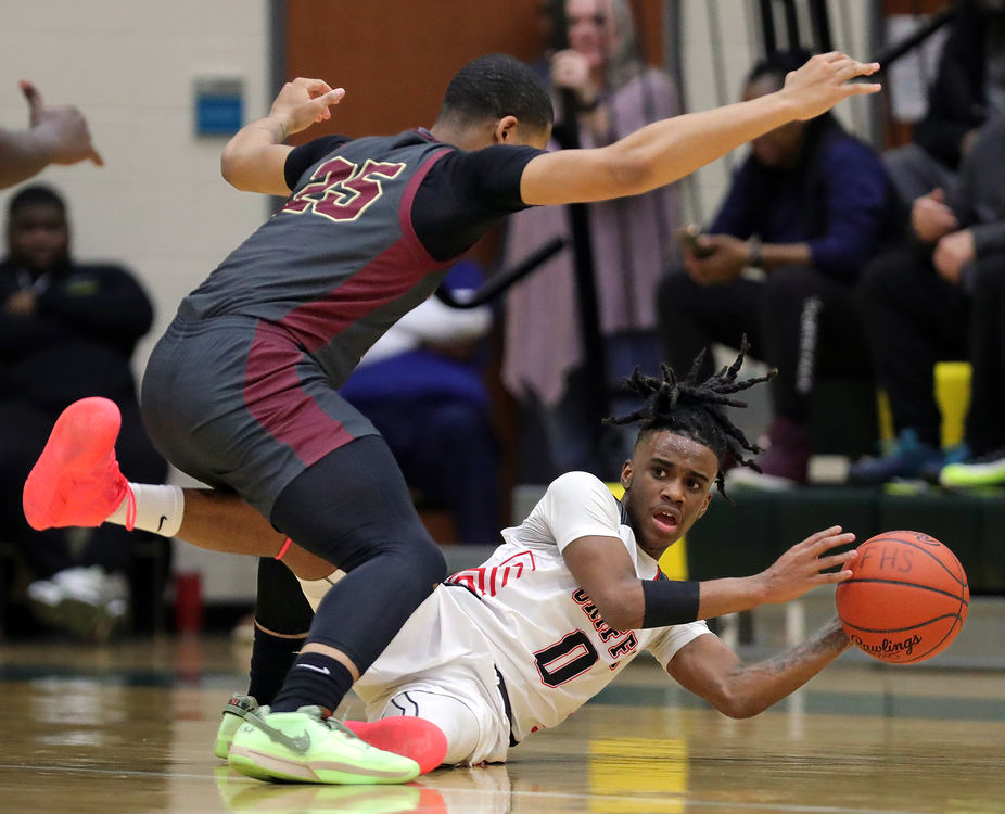  Sports - 2nd place - Buchtel’s Diaire Pride Jr. (bottom) looks to get rid of the ball under Garfield’s Logan Mitchell during the first half of the City Series championship game in Akron. (Jeff Lange / Akron Beacon Journal)}